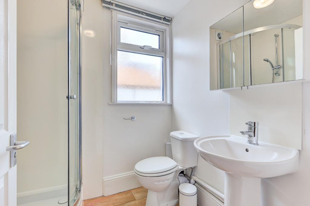 A clean, modern bathroom with a white toilet, s...