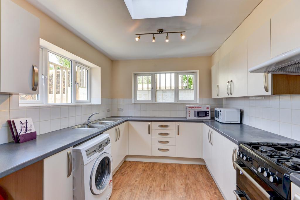 Bright and modern kitchen with ample storage, n...