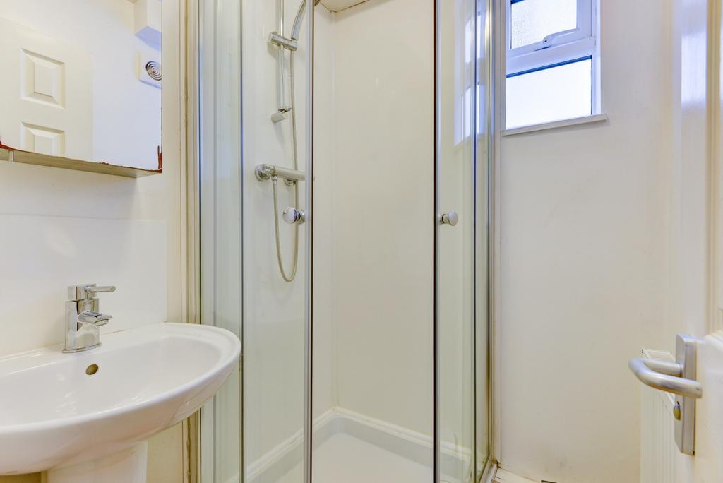 A clean and bright bathroom featuring a shower ...