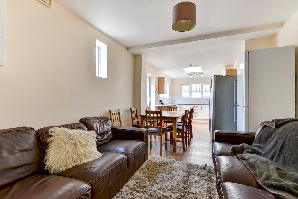 A spacious and welcoming living room with ample...