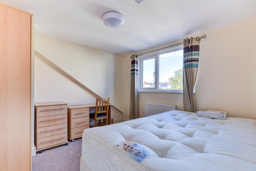 A bright and welcoming double bedroom featuring...