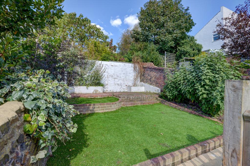 A well-maintained backyard garden featuring lus...