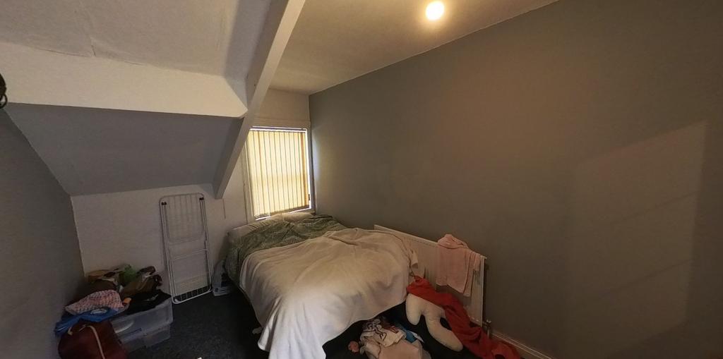 A well-lit bedroom featuring a double bed and a...