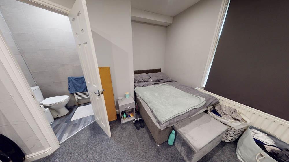 A compact bathroom with a toilet and minimal sp...