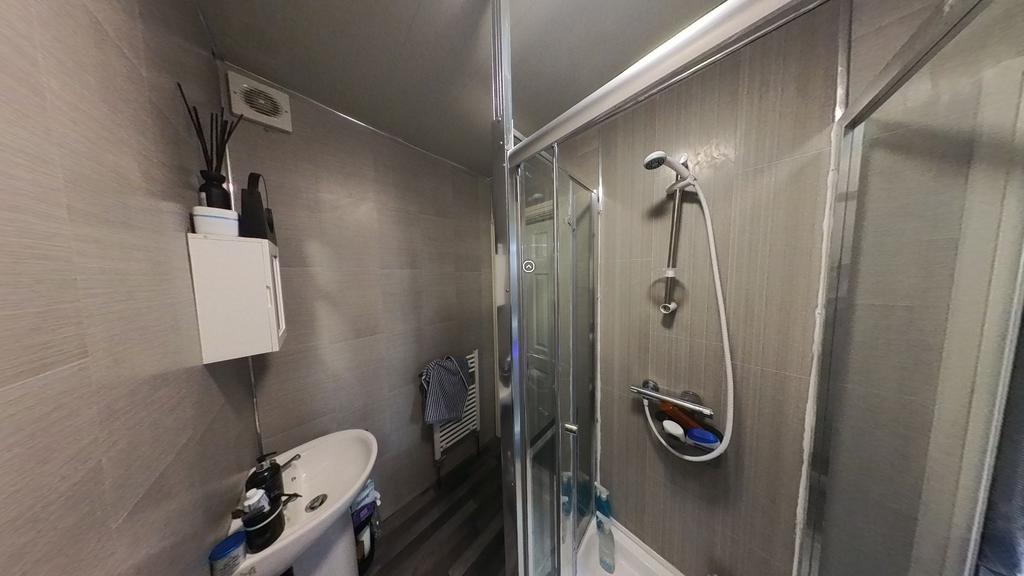 A clean and modern bathroom with a shower enclo...