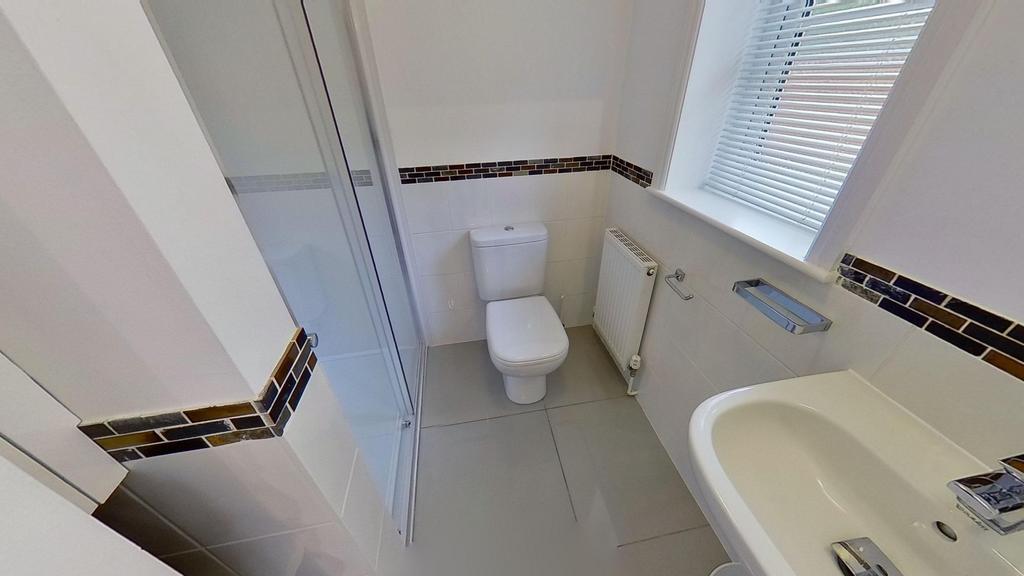 Bright, modern bathroom with white sanitaryware...