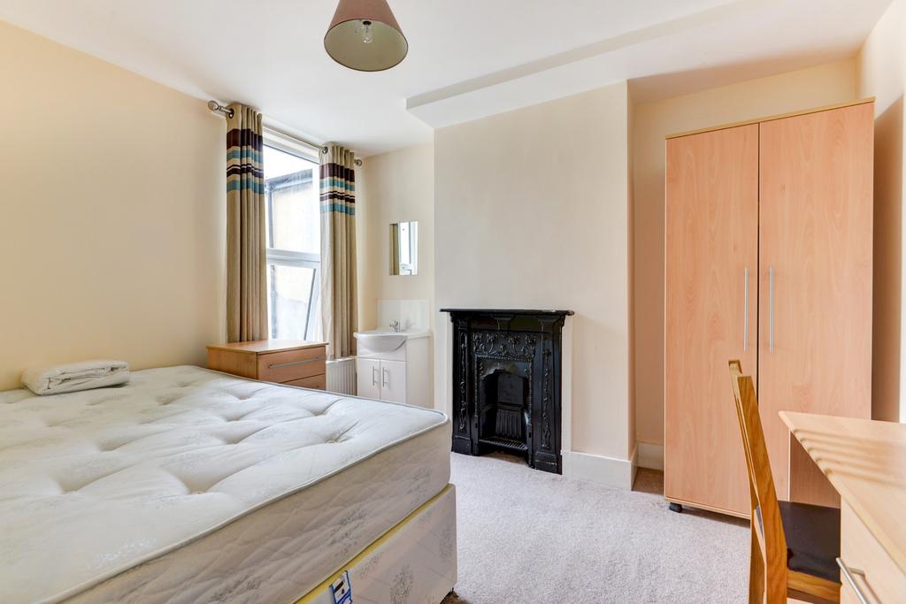 A bright and inviting master bedroom featuring ...