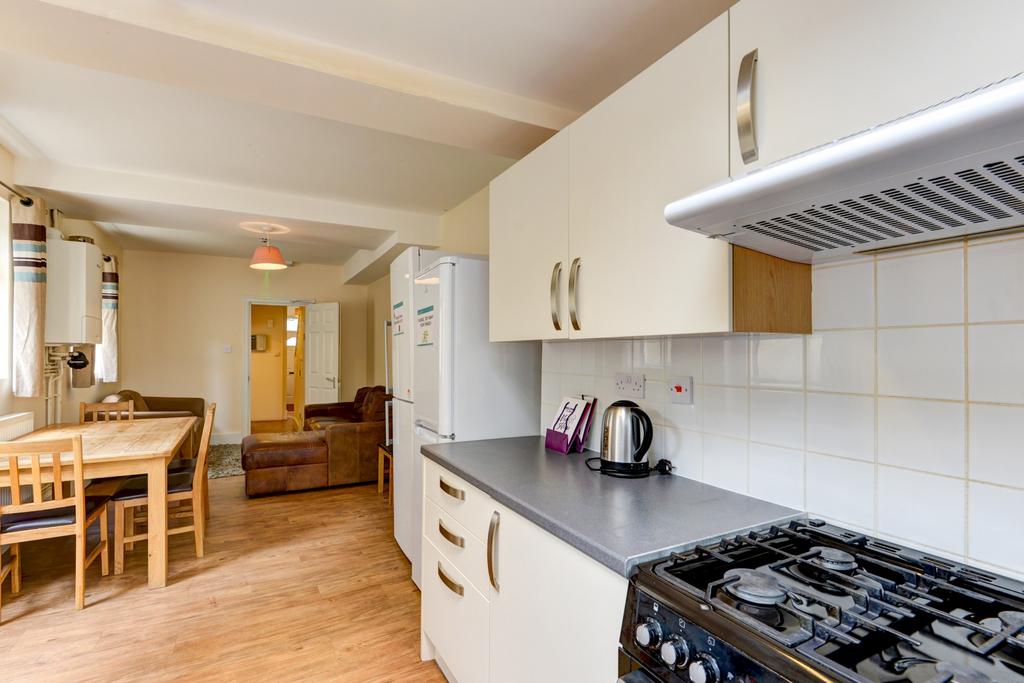 A bright, well-maintained kitchen featuring whi...