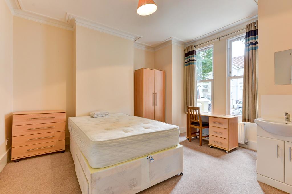 A spacious double bedroom featuring a comfortab...