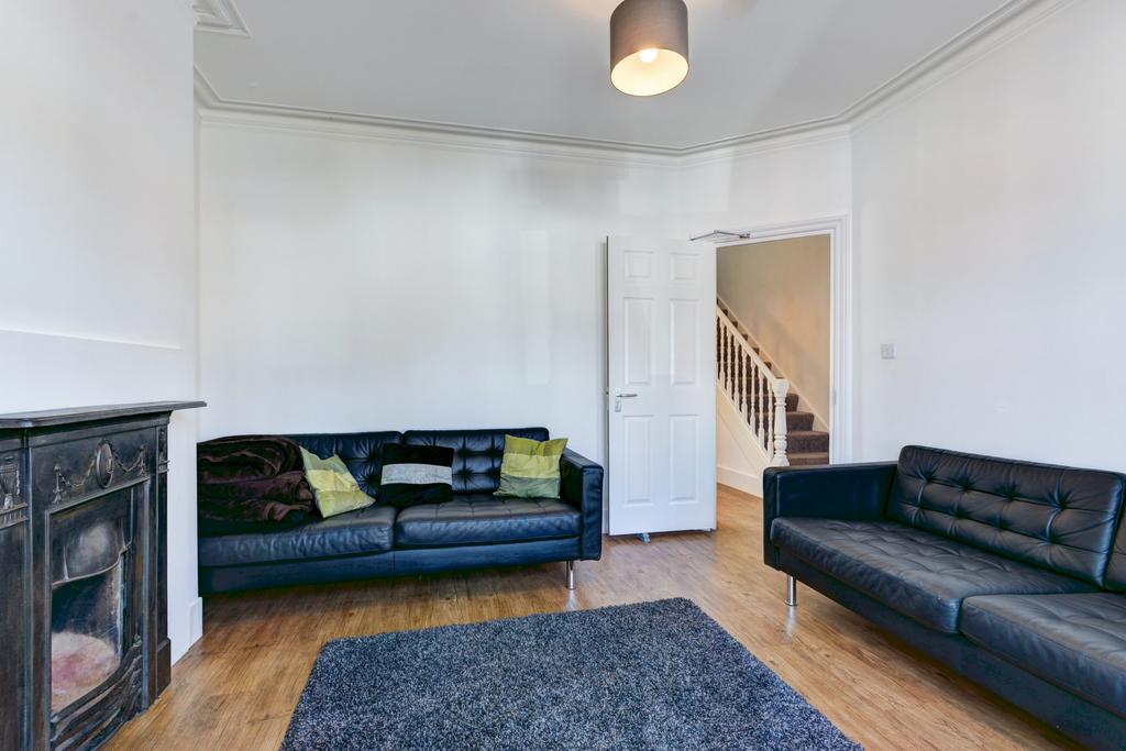 A modern and spacious living room featuring two...