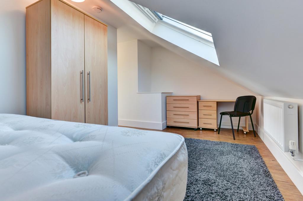 A bright and well-maintained bedroom with a lar...