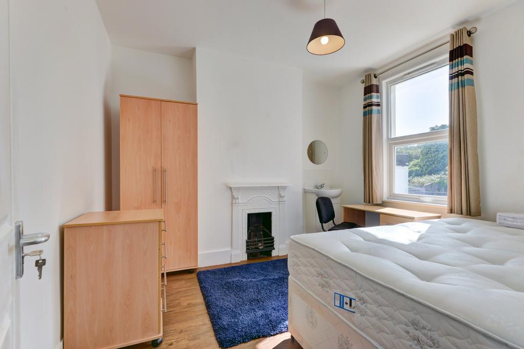 A bright and clean bedroom featuring a comforta...