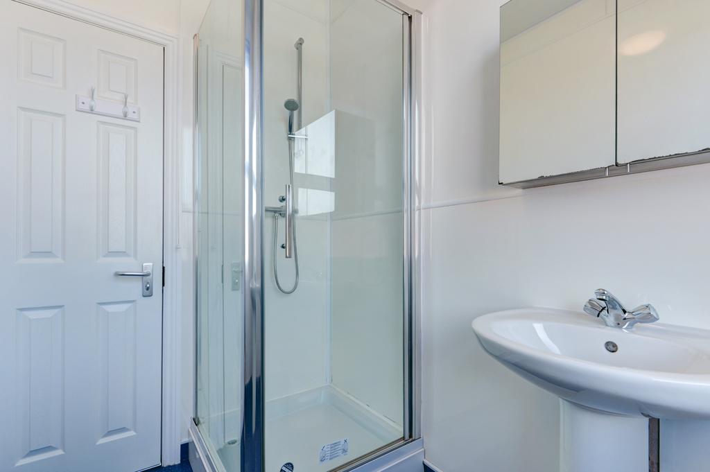 A clean and bright bathroom suite with a large ...
