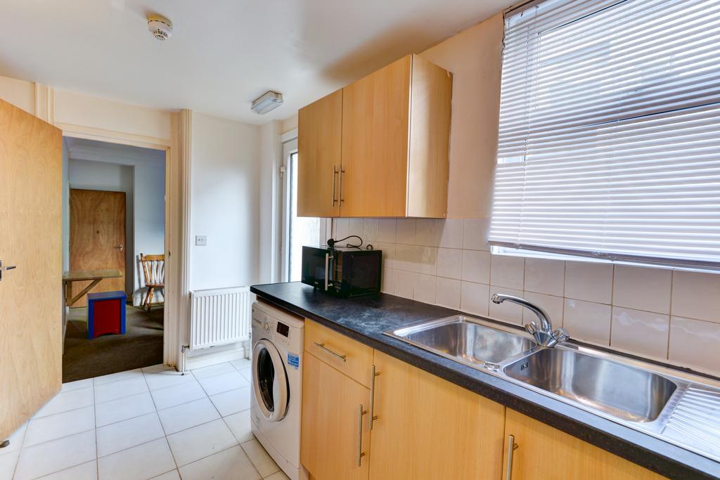 A bright, well-maintained kitchen with wooden c...
