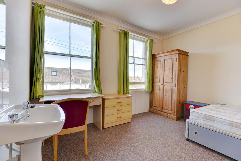 A bright and tidy double bedroom featuring a co...
