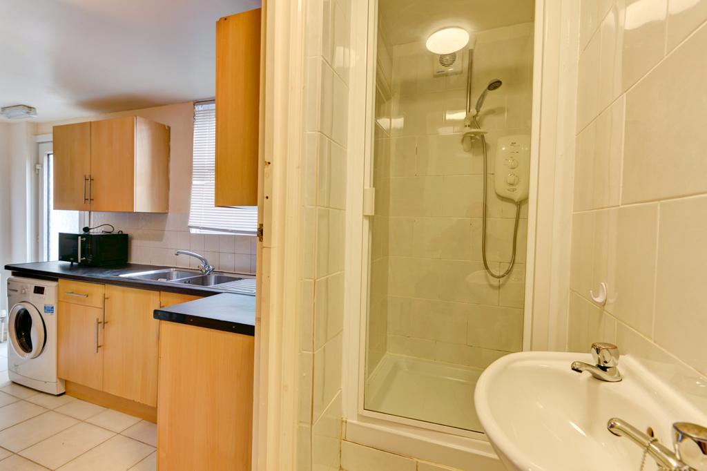 A bright and clean bathroom with a large shower...