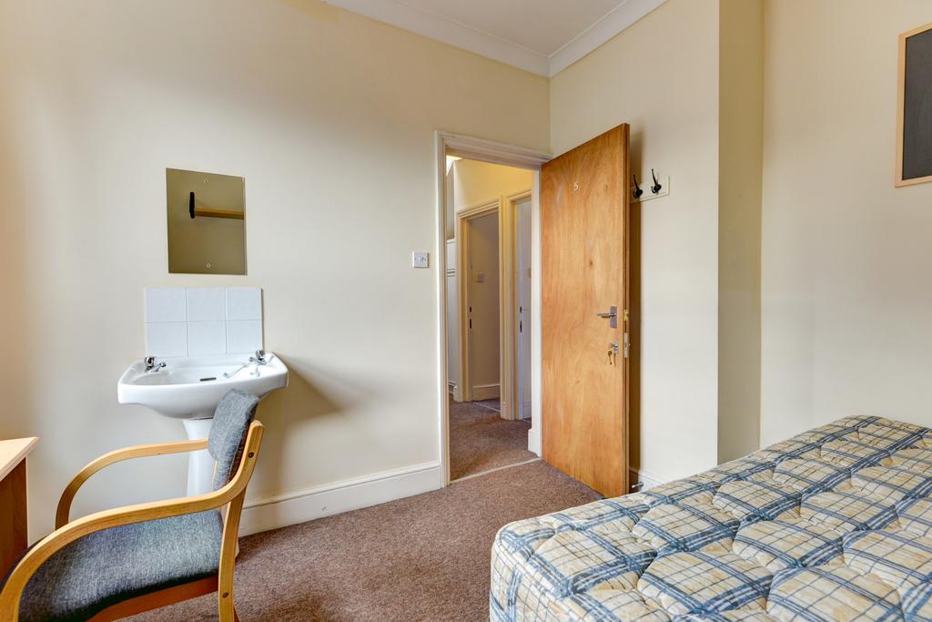 A neat and well-maintained bedroom featuring a ...