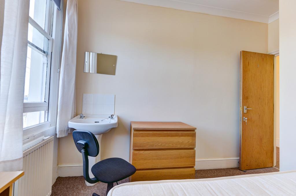 A bright and clean small room featuring a sink ...