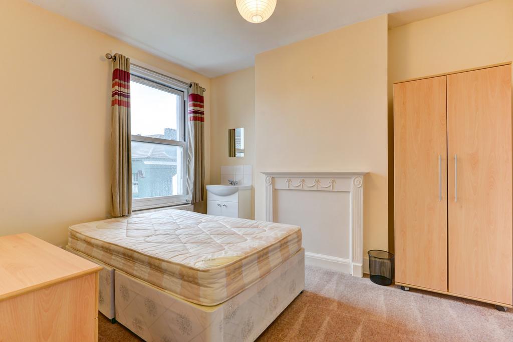 A neatly maintained bedroom featuring a double ...