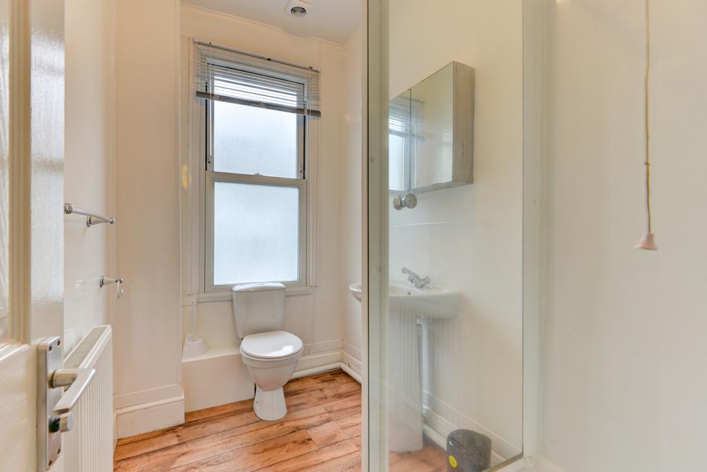A bright and clean bathroom featuring a toilet,...