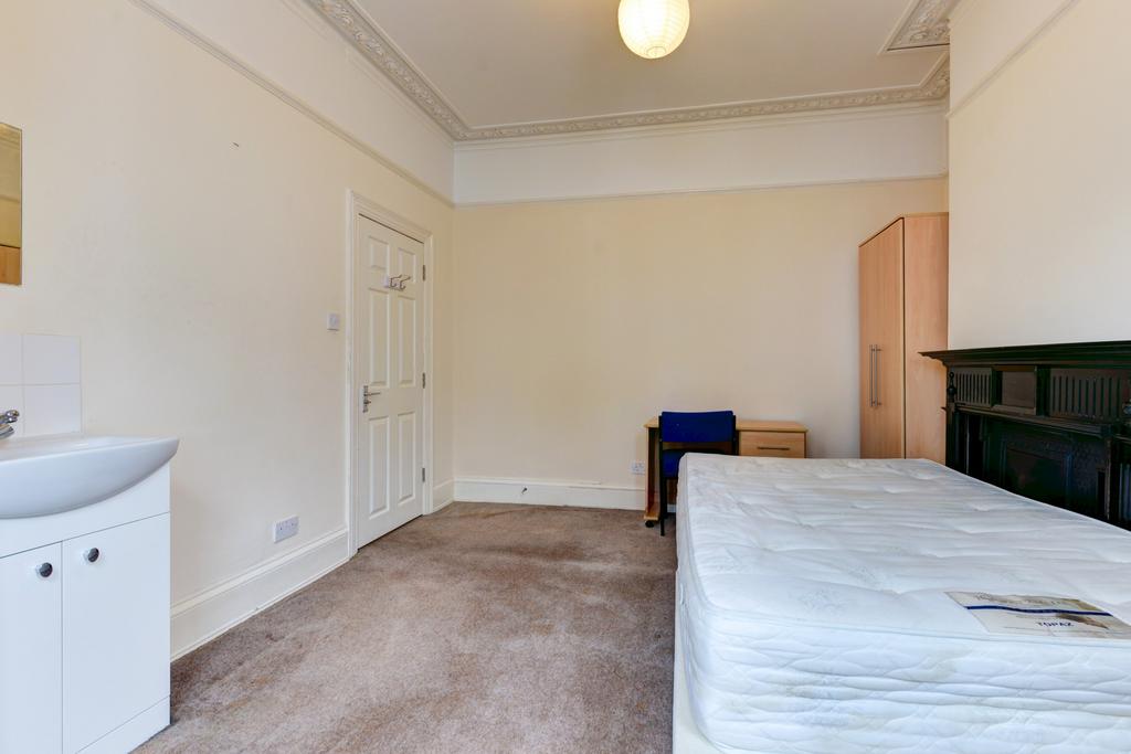 A spacious master bedroom with a large bed and ...