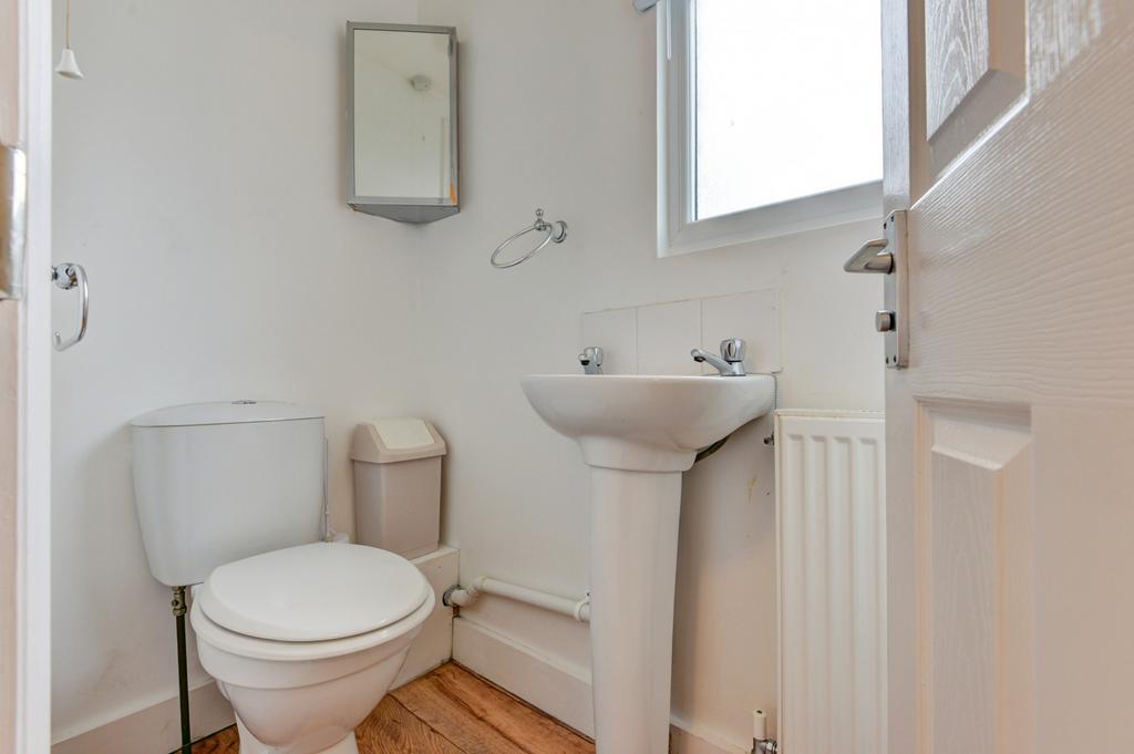 A clean and bright bathroom featuring a toilet,...