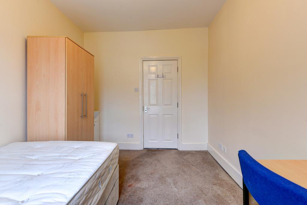 A simple, clean bedroom featuring a bed and a w...