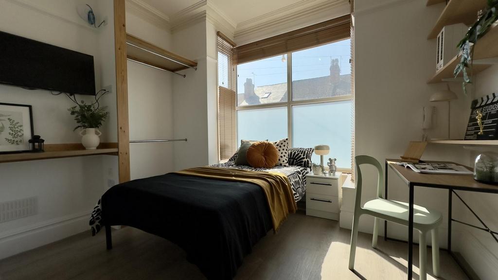 A bright and inviting double bedroom with ample...