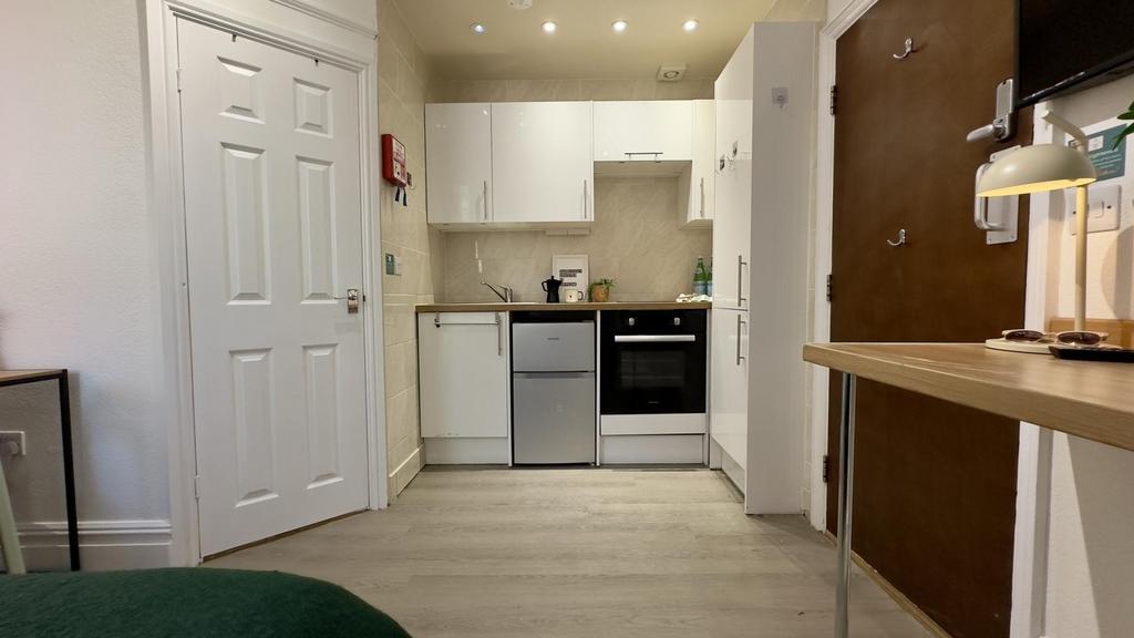 A modern and well-maintained kitchenette with a...