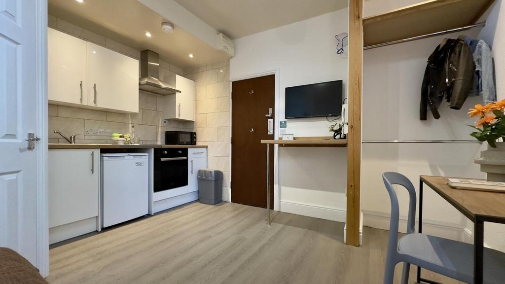 A modern and tidy kitchenette with bright light...