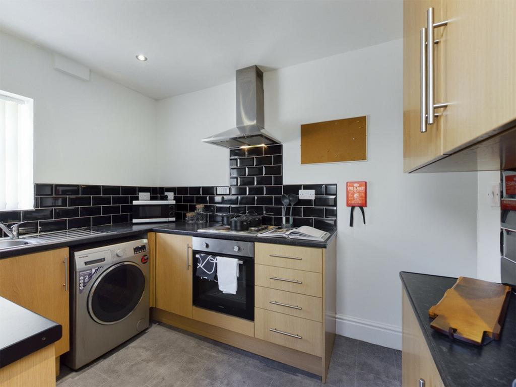 A modern kitchenette featuring sleek cabinetry ...