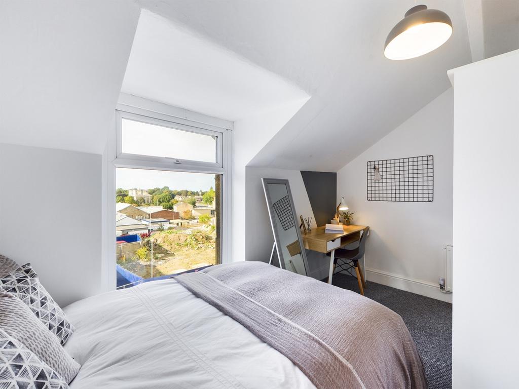 A bright and inviting double bedroom featuring ...