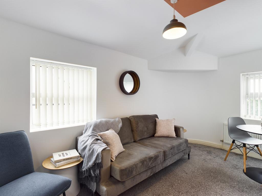 A bright and inviting living room with comforta...