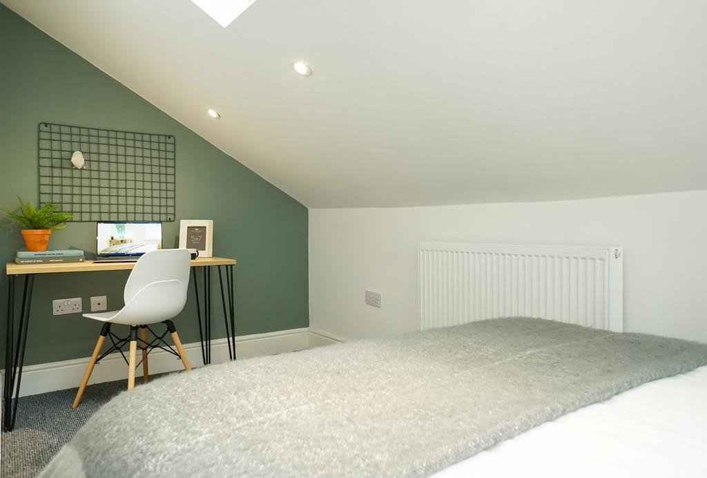 A bright and modern double bedroom featuring a ...