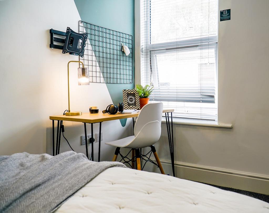 A stylish and well-lit double bedroom featuring...