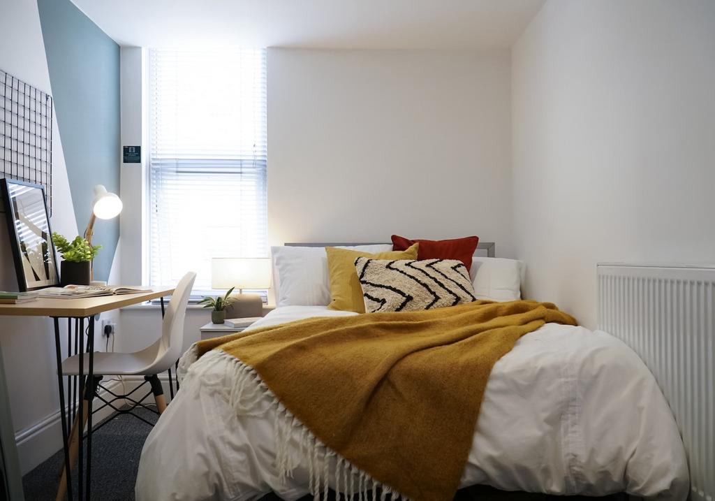 A bright and inviting double bedroom with moder...