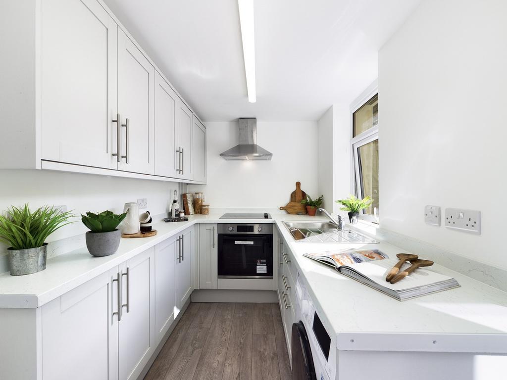 A bright and modern kitchenette with sleek fini...