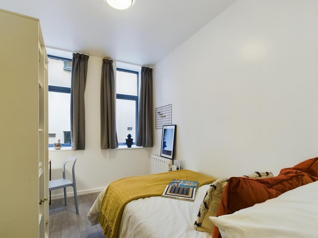 A bright and cozy double bedroom featuring ampl...