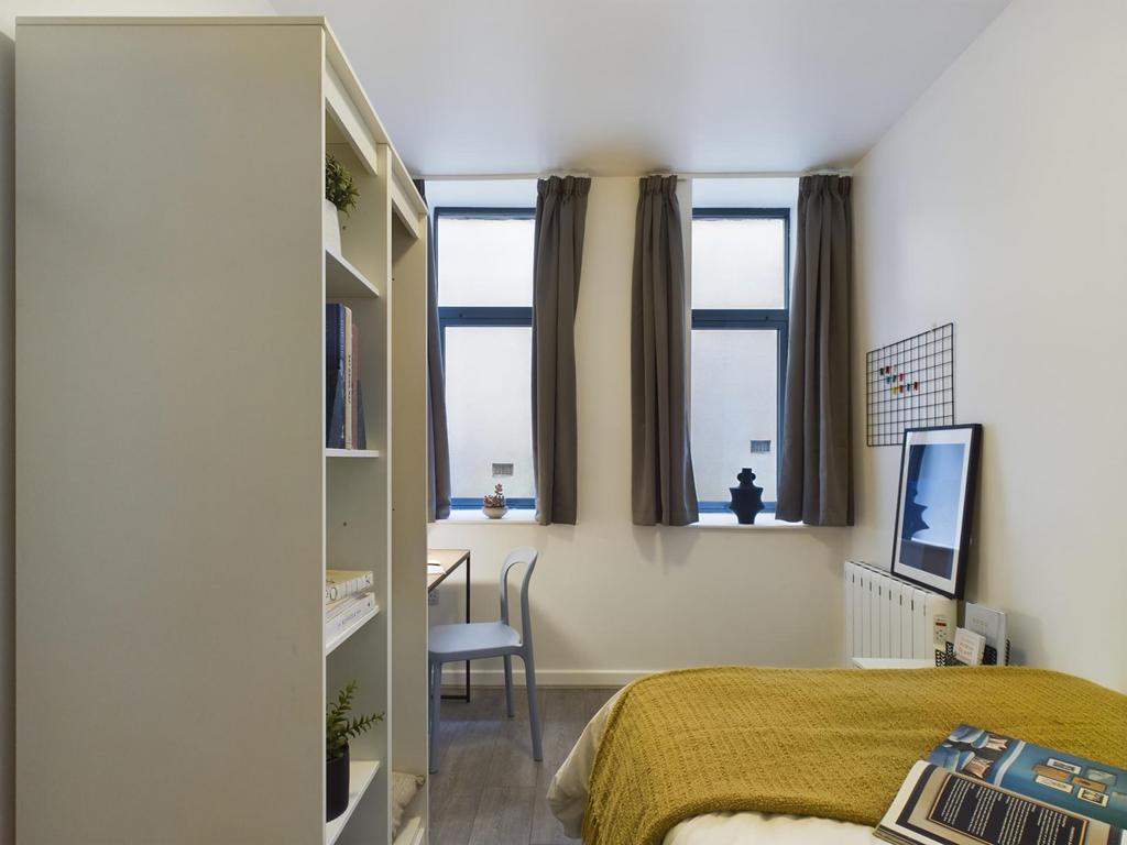 A bright and inviting double bedroom featuring ...