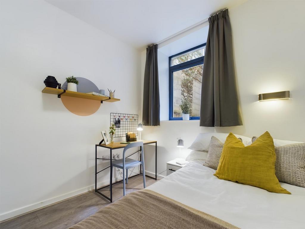 A bright and stylish double bedroom featuring a...