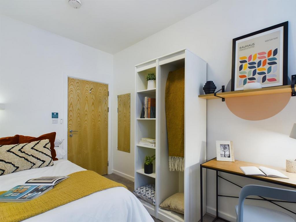 A bright and inviting double bedroom with a coz...