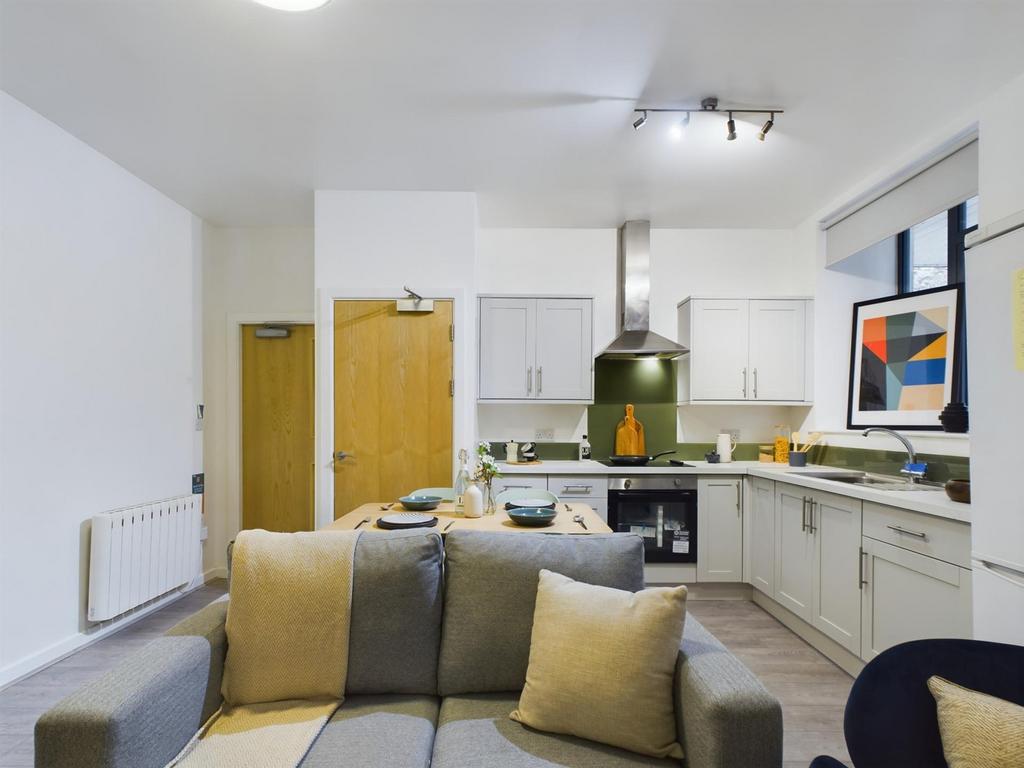 A modern and inviting kitchenette with ample na...