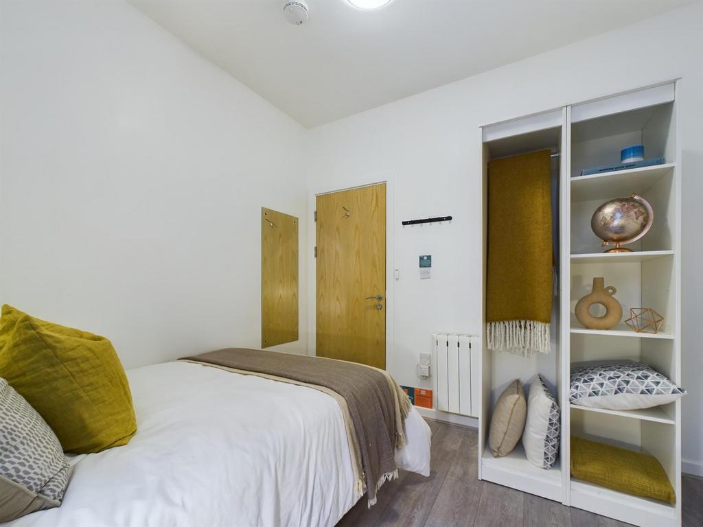 A bright and inviting double bedroom featuring ...