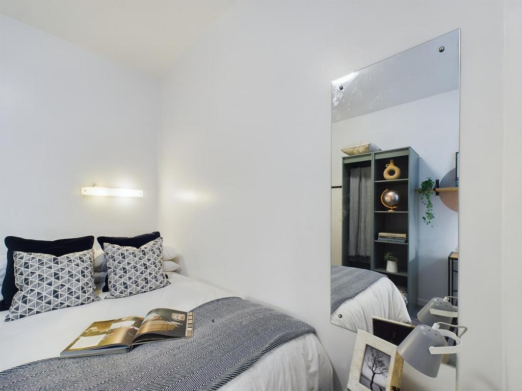 A bright and inviting double bedroom featuring ...
