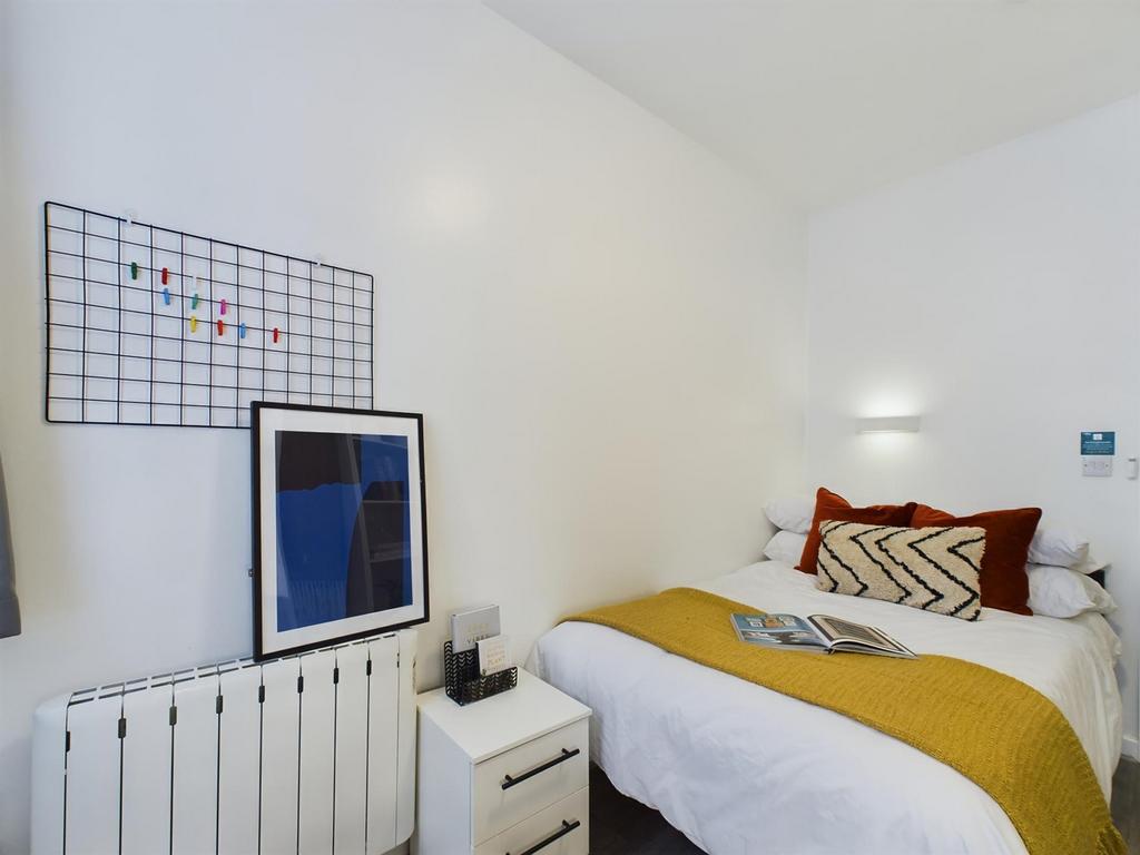 A bright and inviting double bedroom featuring ...