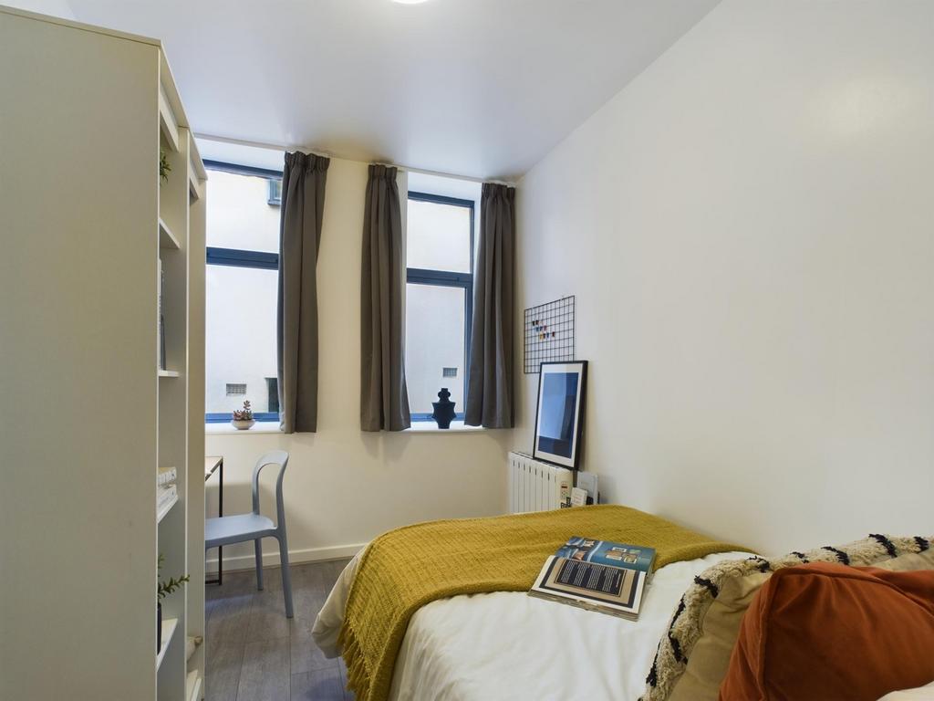 A bright and inviting double bedroom with moder...
