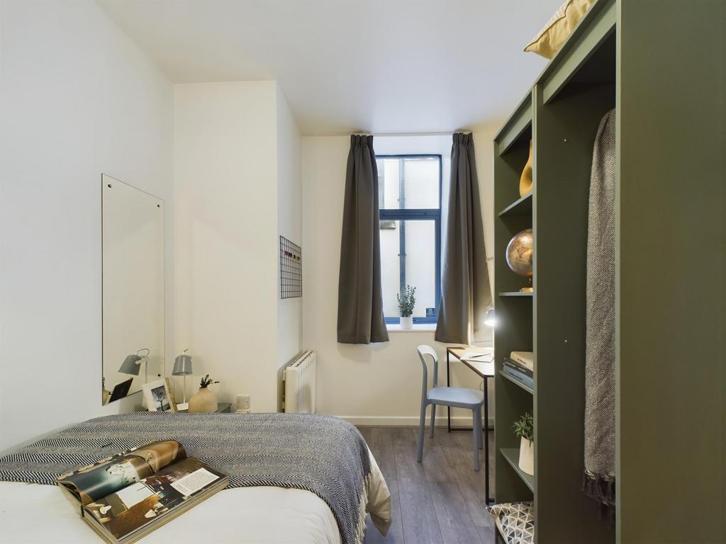 A bright and inviting double bedroom featuring ...