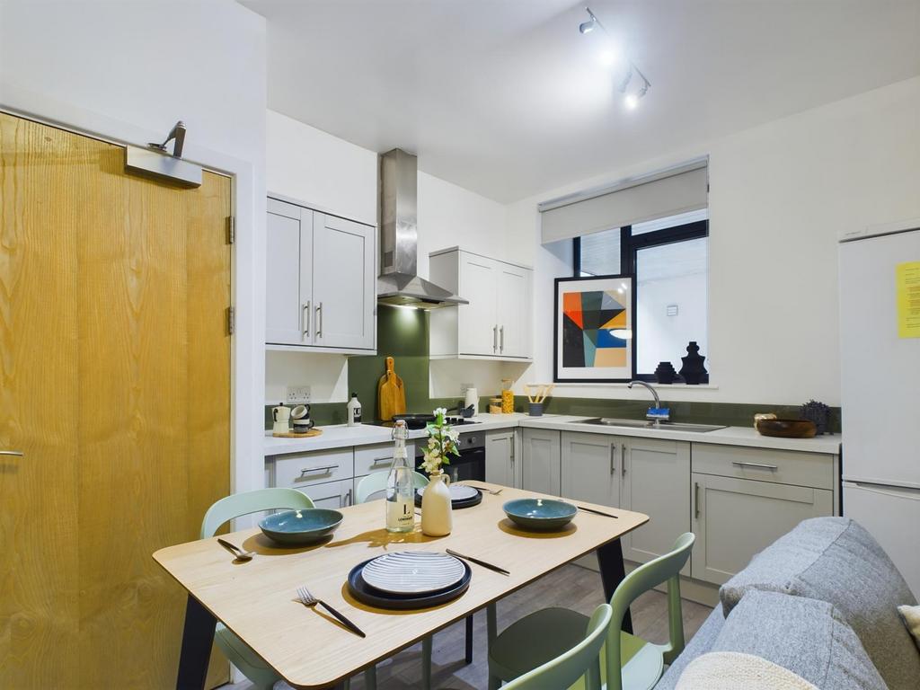 A modern and inviting kitchenette with ample sp...