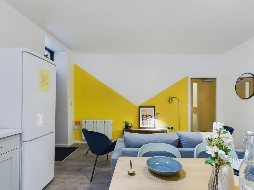 A bright and modern living room featuring a sty...