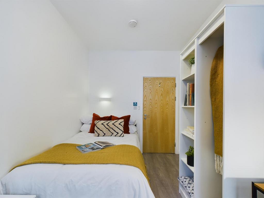 A bright and inviting double bedroom featuring ...